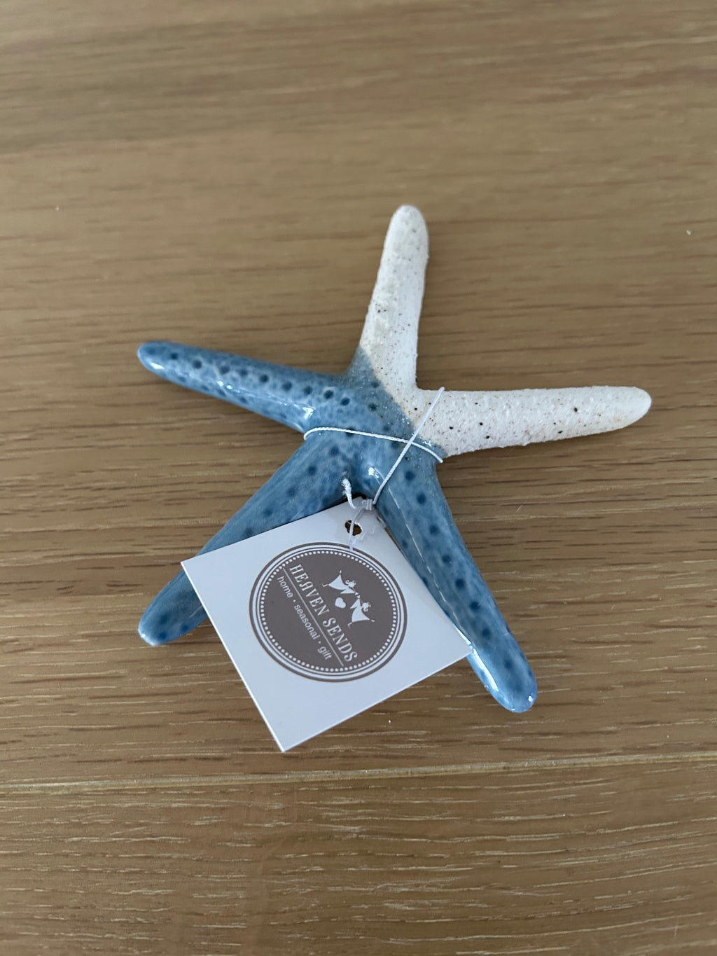 Decorative starfish with a tag on a wooden surface