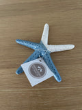 Decorative starfish with a tag on a wooden surface