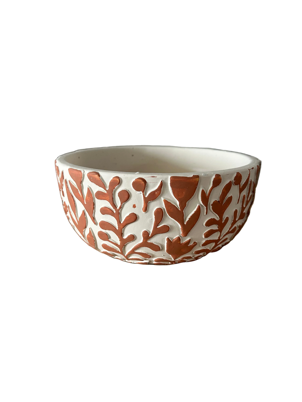 Ceramic bowl with orange leaf pattern on a white background